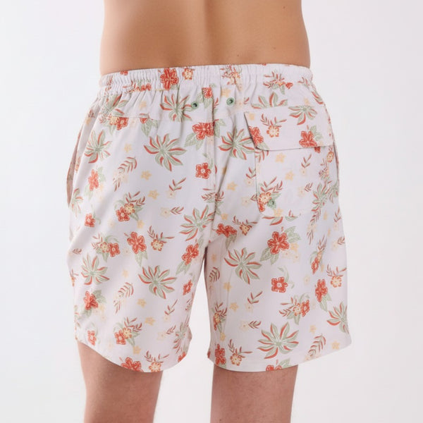 Back view of COAST vintage tropical swim shorts with coral and sage floral print, showing rear flap pocket with drainage grommets.