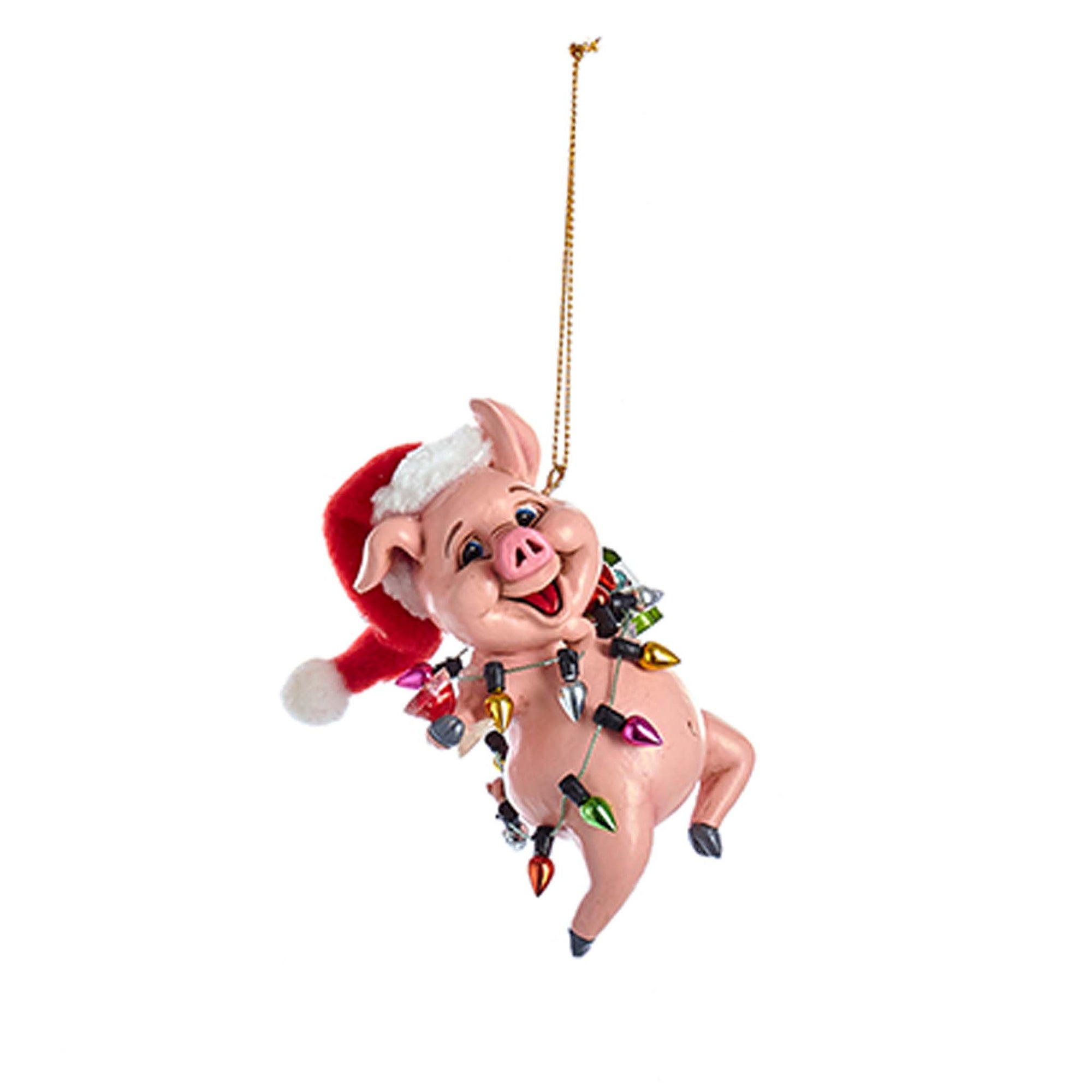 Pink pig ornament wearing a Santa hat and wrapped in colorful Christmas lights, hanging holiday decoration.