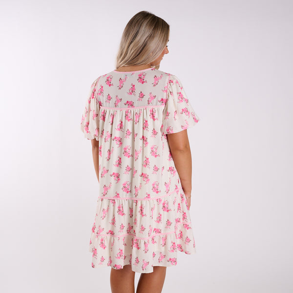 Woman wearing a floral dress on a white background