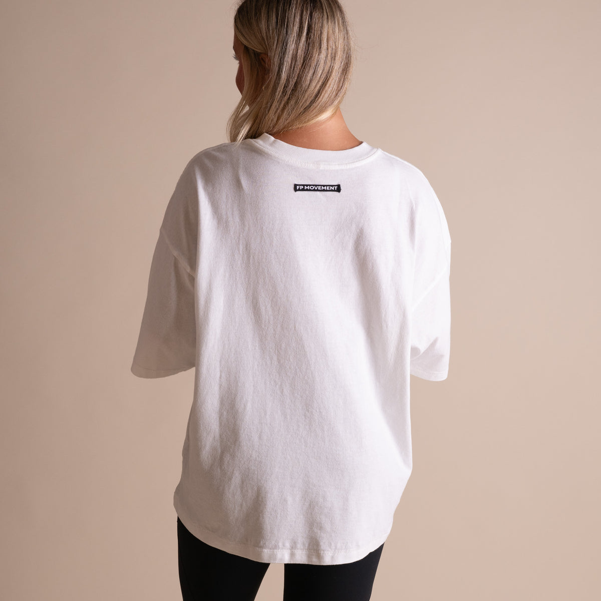 Woman wearing FP Movement Tackle Tee in White