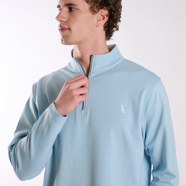 Man wearing Local Boy Outfitters Bentley Quarter Zip Pullover in Columbia Blue on a white background