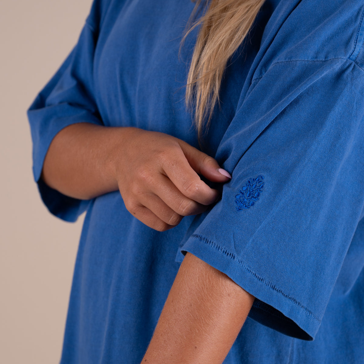 Woman wearing FP Movement Tackle Tee in Light Cobalt Blue