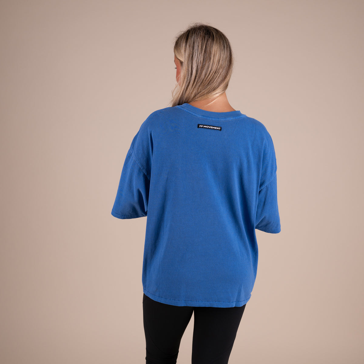 Woman wearing FP Movement Tackle Tee in Light Cobalt Blue