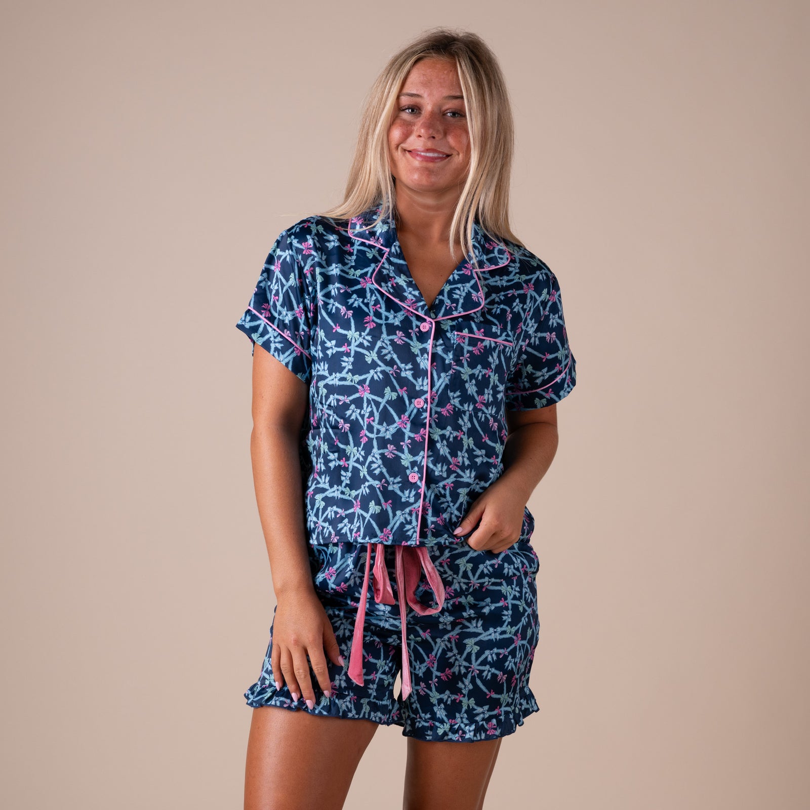 Front view of women’s Simply Southern navy bow pajama set featuring pink piping and velvet drawstring waist.