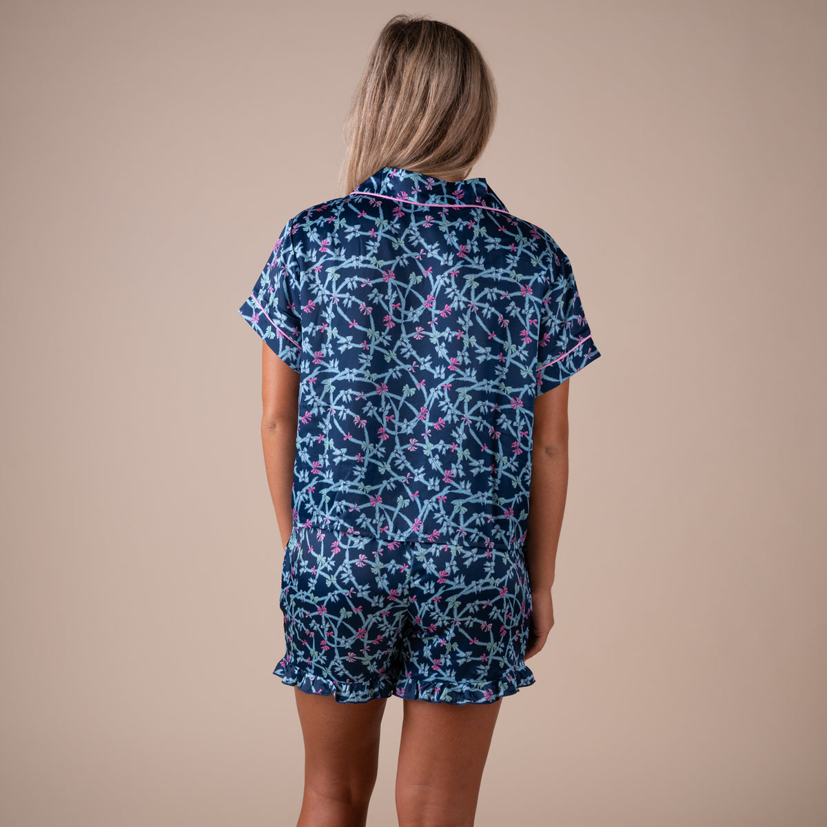 Back view of Simply Southern navy bow pajama set with button-down top and ruffle-hem shorts