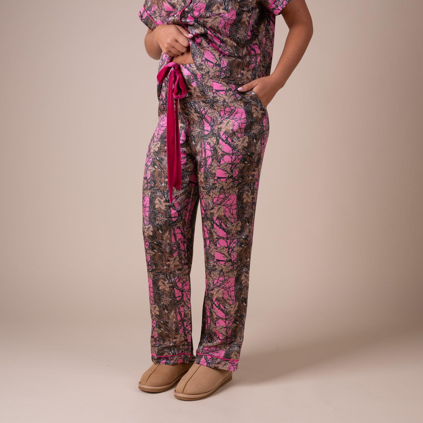 Side view of women’s Simply Southern pink camo pajama pants with velvet drawstring waist and relaxed fit.