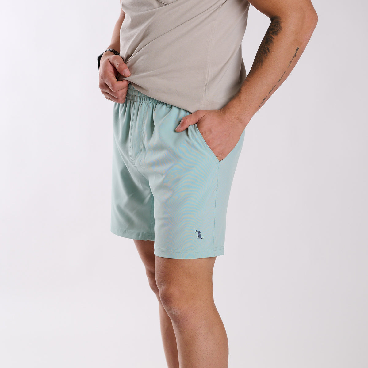 Man wearing Local Boy Outfitters Volley Shorts in Mint with a 6" inseam standing in front of a white background