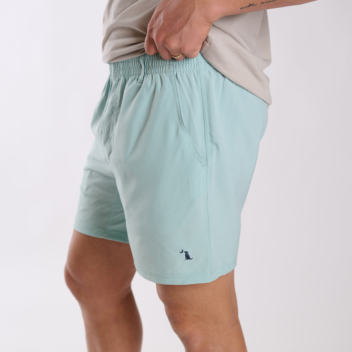 Man wearing Local Boy Outfitters Volley Shorts in Mint with a 6" inseam standing in front of a white background