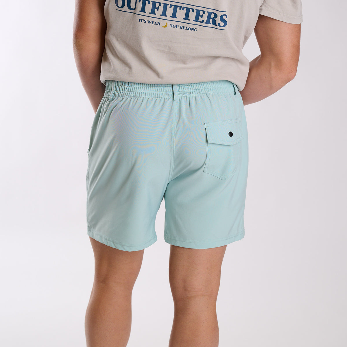 Man wearing Local Boy Outfitters Volley Shorts in Mint with a 6" inseam standing in front of a white background