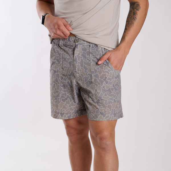 Man wearing 6 Inch Chum Shorts in Gray Cobblestone Camo in front of a white background