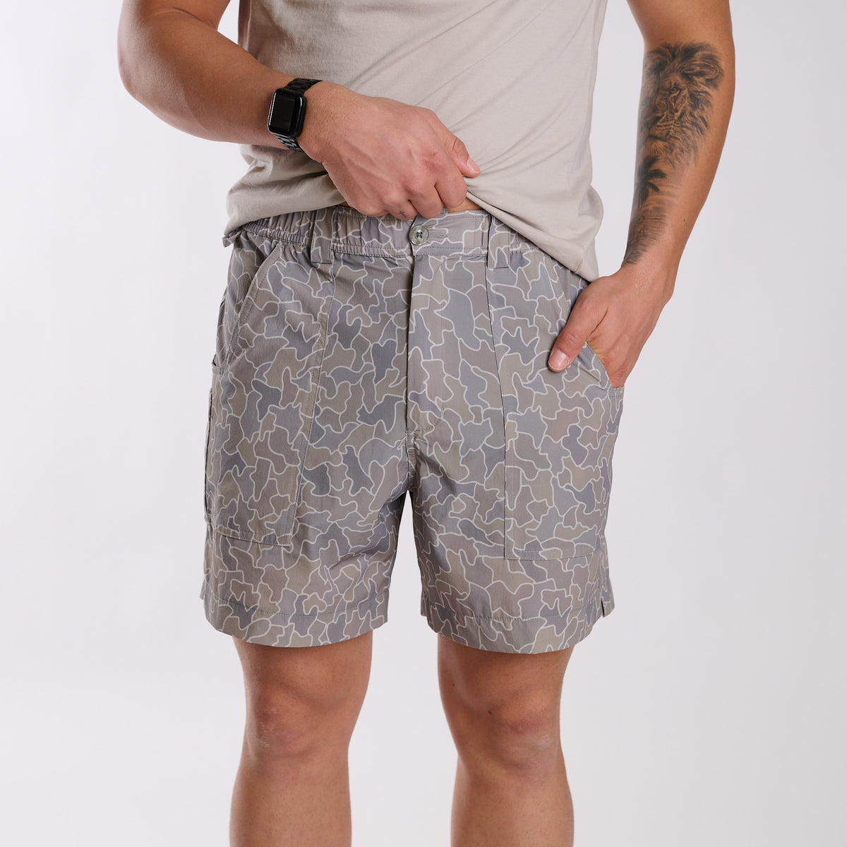 Man wearing 6 Inch Chum Shorts in Gray Cobblestone Camo in front of a white background
