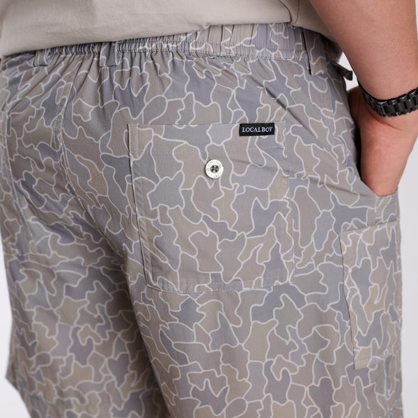 Man wearing 6 Inch Chum Shorts in Gray Cobblestone Camo in front of a white background