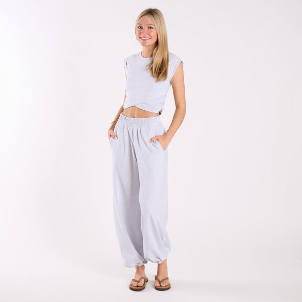  Woman wearing a light heather grey crop top and light heather gray wide-leg pants on a white background