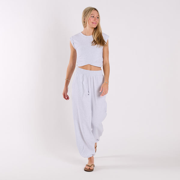  Woman wearing a light heather grey crop top and light heather gray wide-leg pants on a white background
