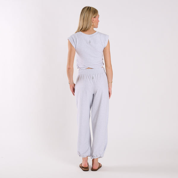  Woman wearing a light heather grey crop top and light heather gray wide-leg pants on a white background