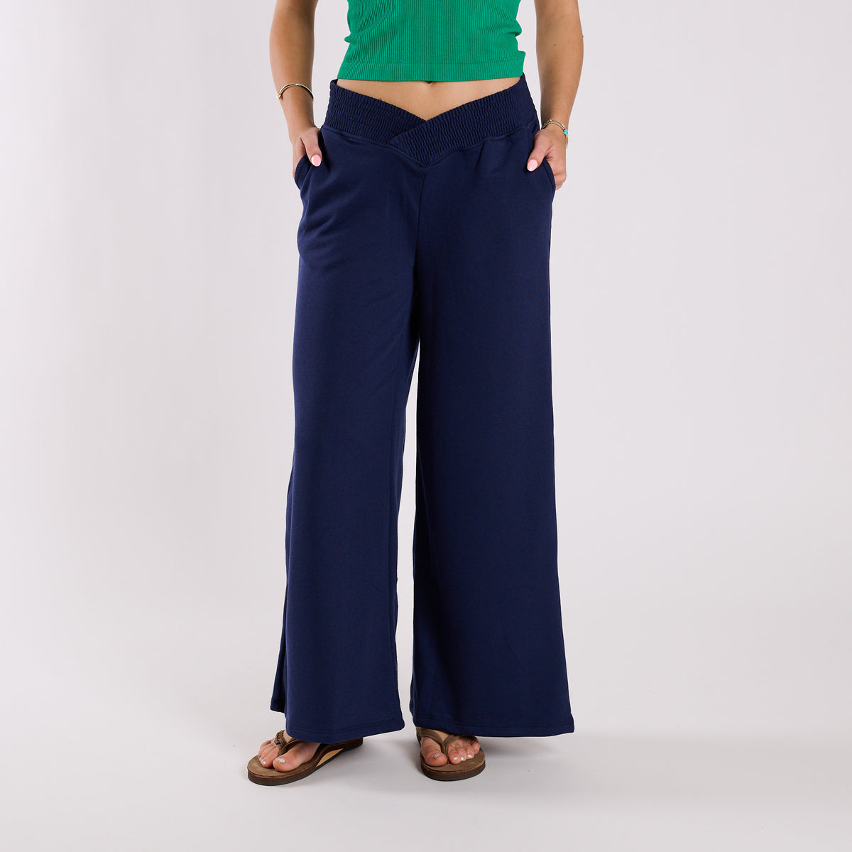 Navy wide-leg pants worn by a person on a white background