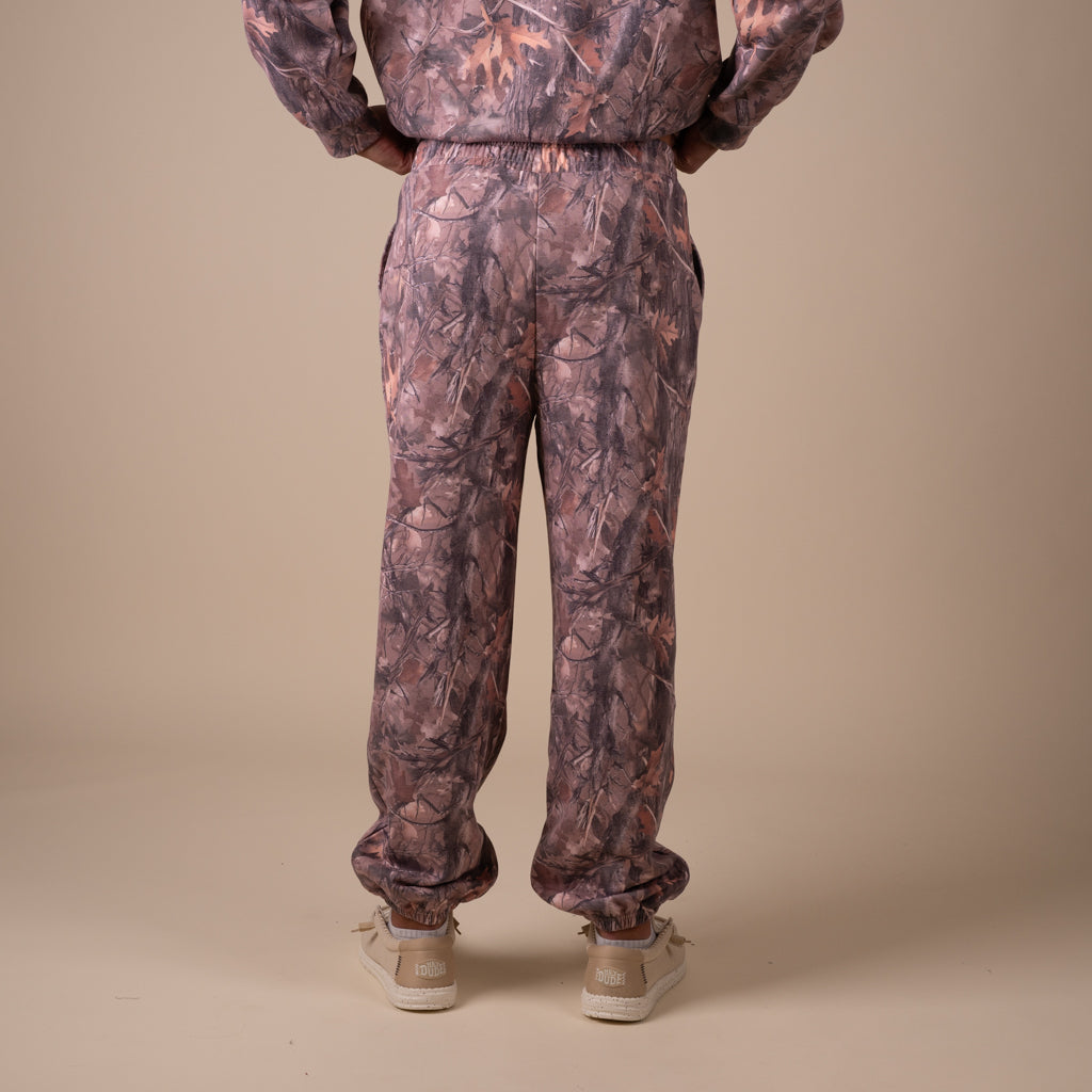Back of Man wearing a camoflauge outfit with a sweatshirt and sweatpants.
