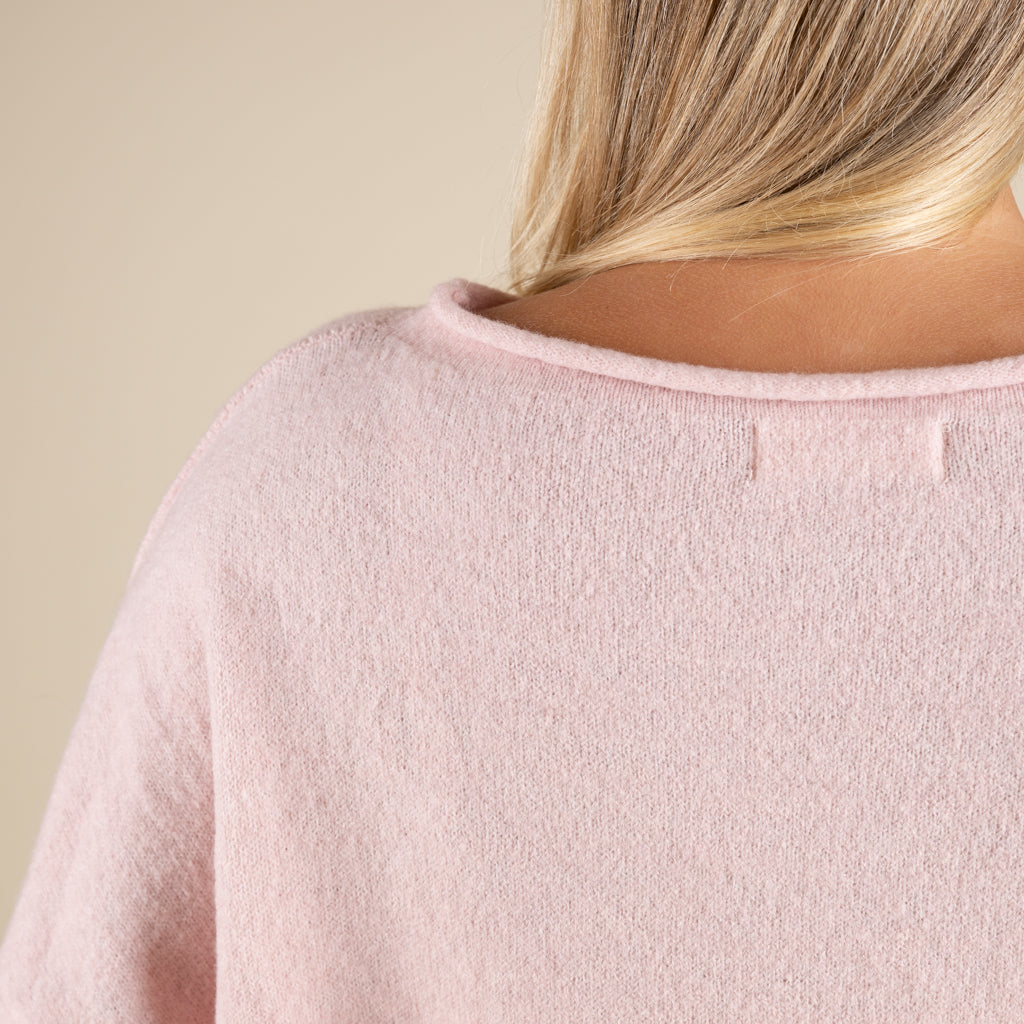 Close-up of a pink textured garment with a neutral background