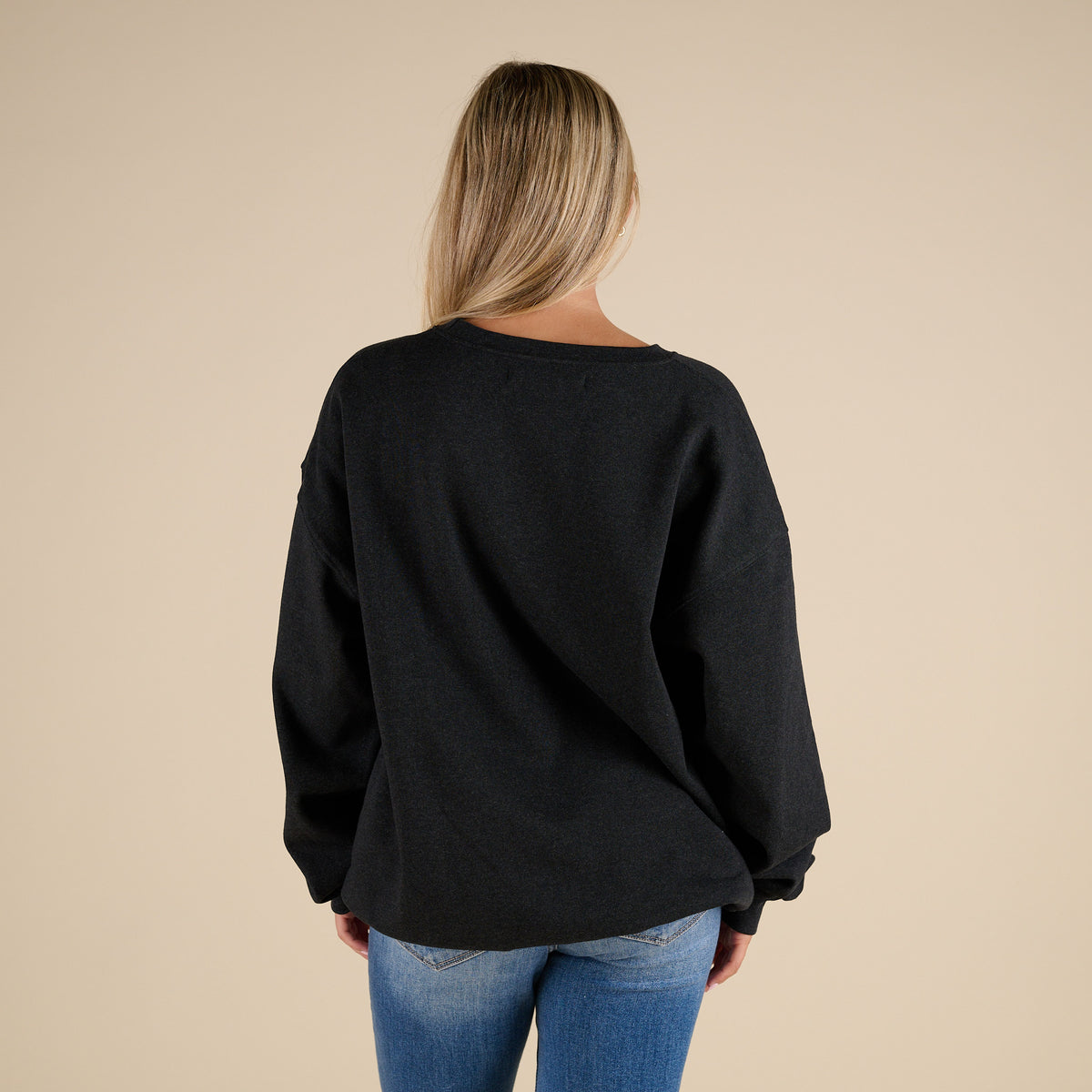 Model Wearing a black simply southern sweatshirt with large pink camo bow on the front and black back.