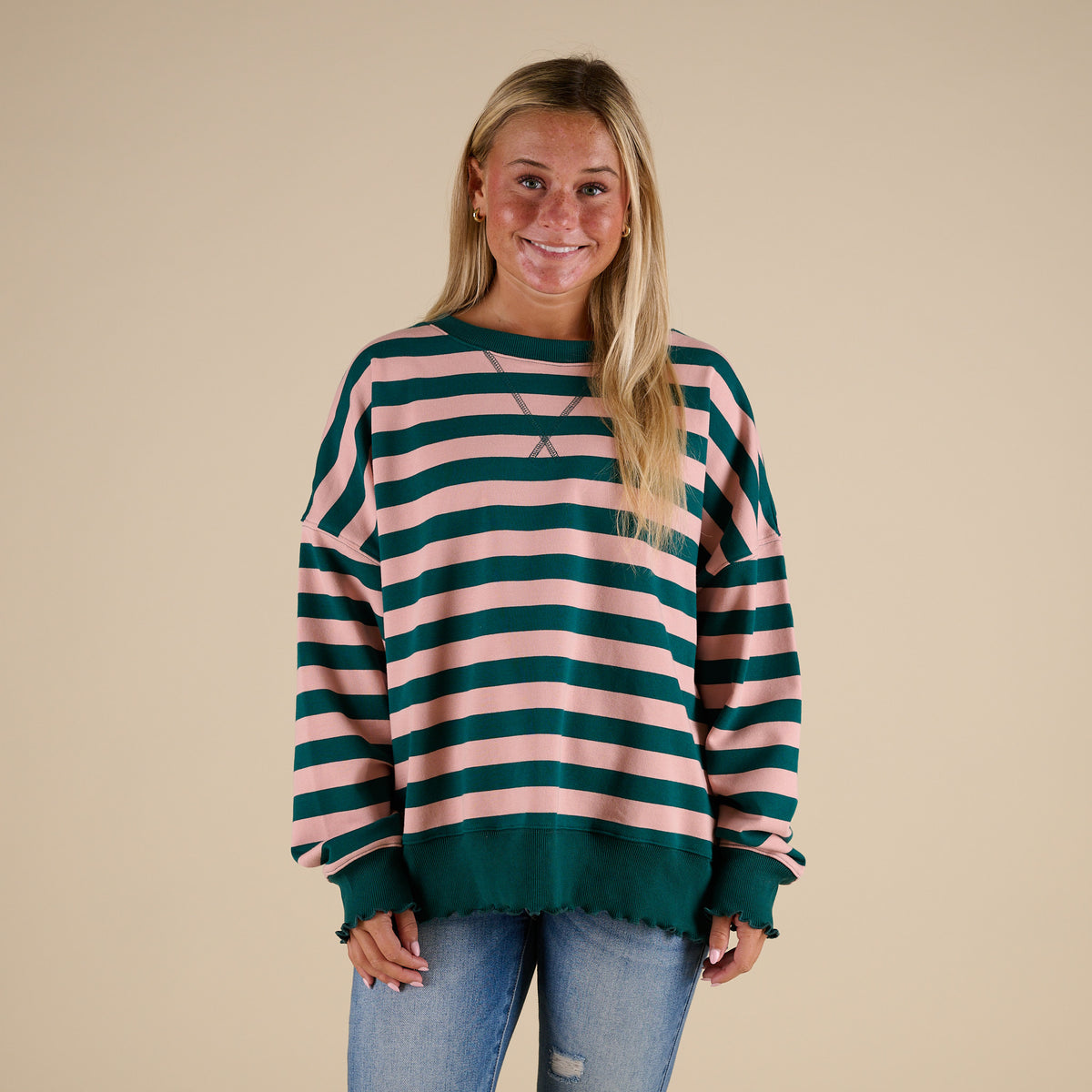 woman wearing a Fantastic Fawn Striped Crewneck Sweatshirt in Green and Pink