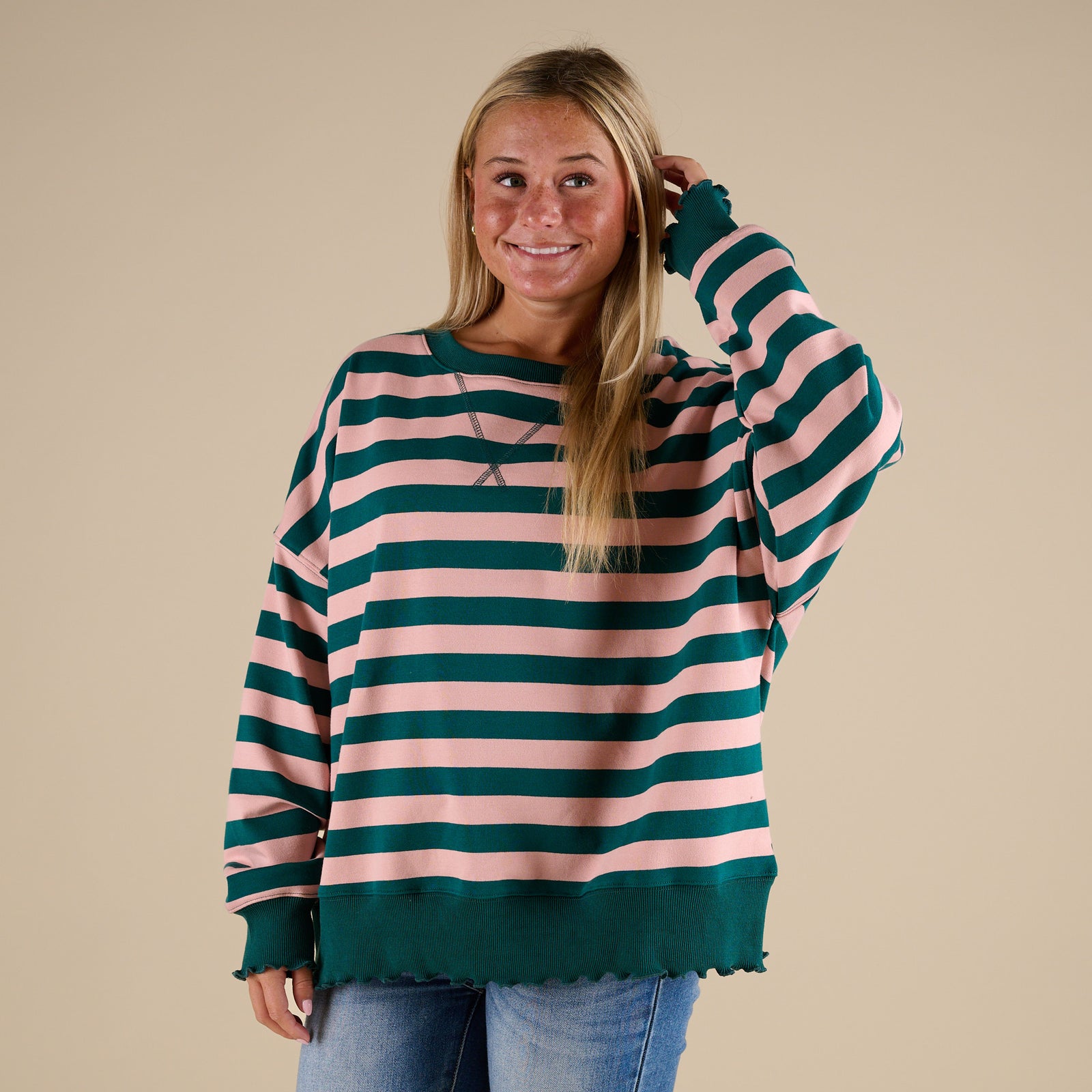 woman wearing a Fantastic Fawn Striped Crewneck Sweatshirt in Green and Pink