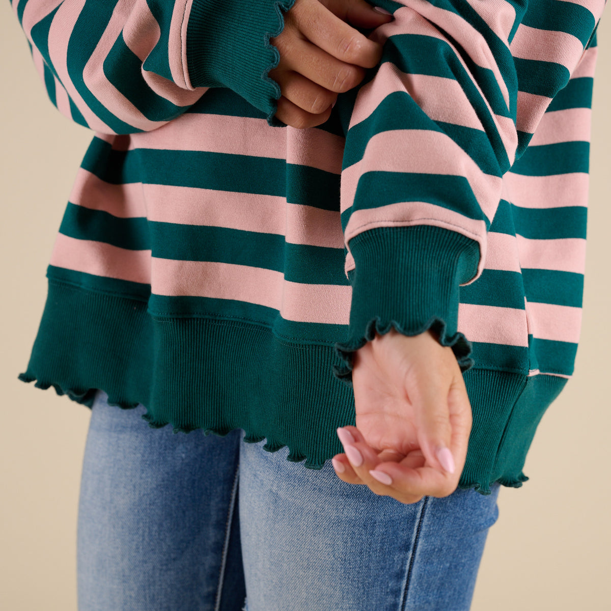 woman wearing a Fantastic Fawn Striped Crewneck Sweatshirt in Green and Pink