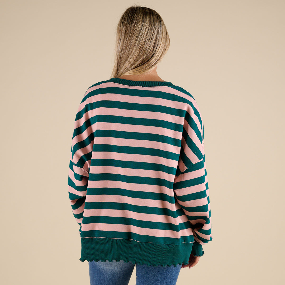 woman wearing a Fantastic Fawn Striped Crewneck Sweatshirt in Green and Pink