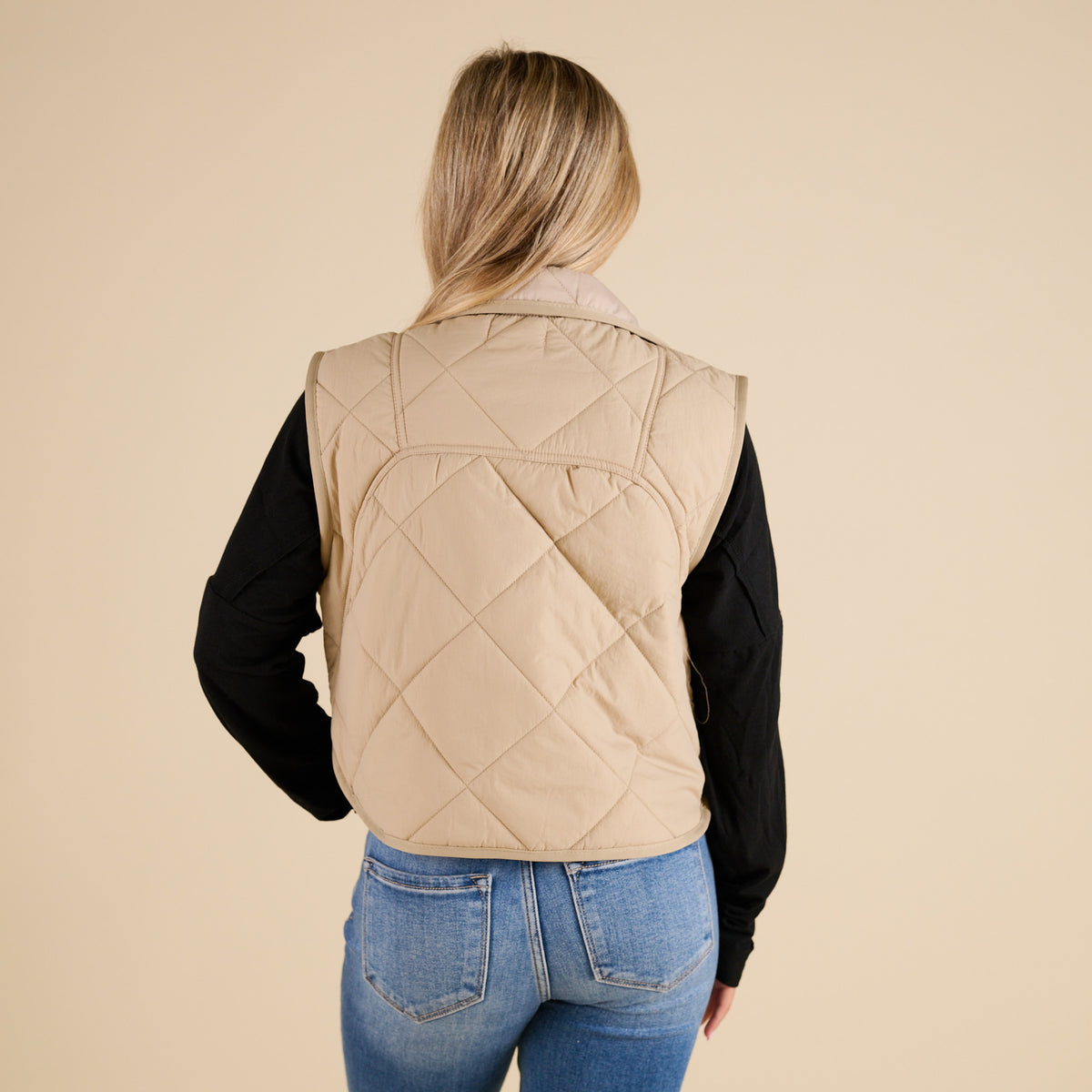 Blu Pepper Quilted Light Snap Vest in Khaki shown on model wearing a black long sleeve top and jeans, featuring quilted detailing and snap-front closure