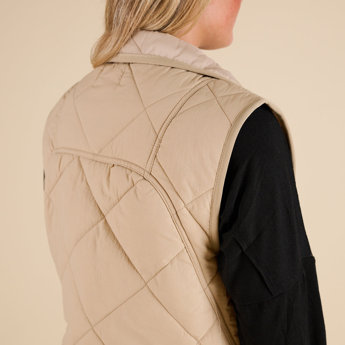 Blu Pepper Quilted Light Snap Vest in Khaki shown on model wearing a black long sleeve top and jeans, featuring quilted detailing and snap-front closure