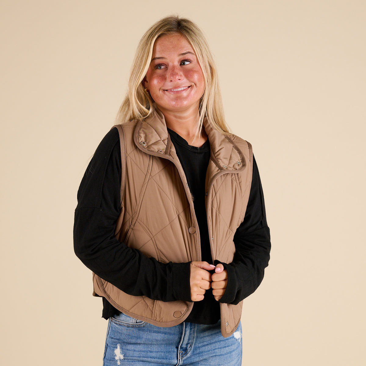 Blu Pepper Quilted Light Snap Vest in Mocha shown on model wearing a black long sleeve top and jeans, featuring quilted detailing and snap-front closure