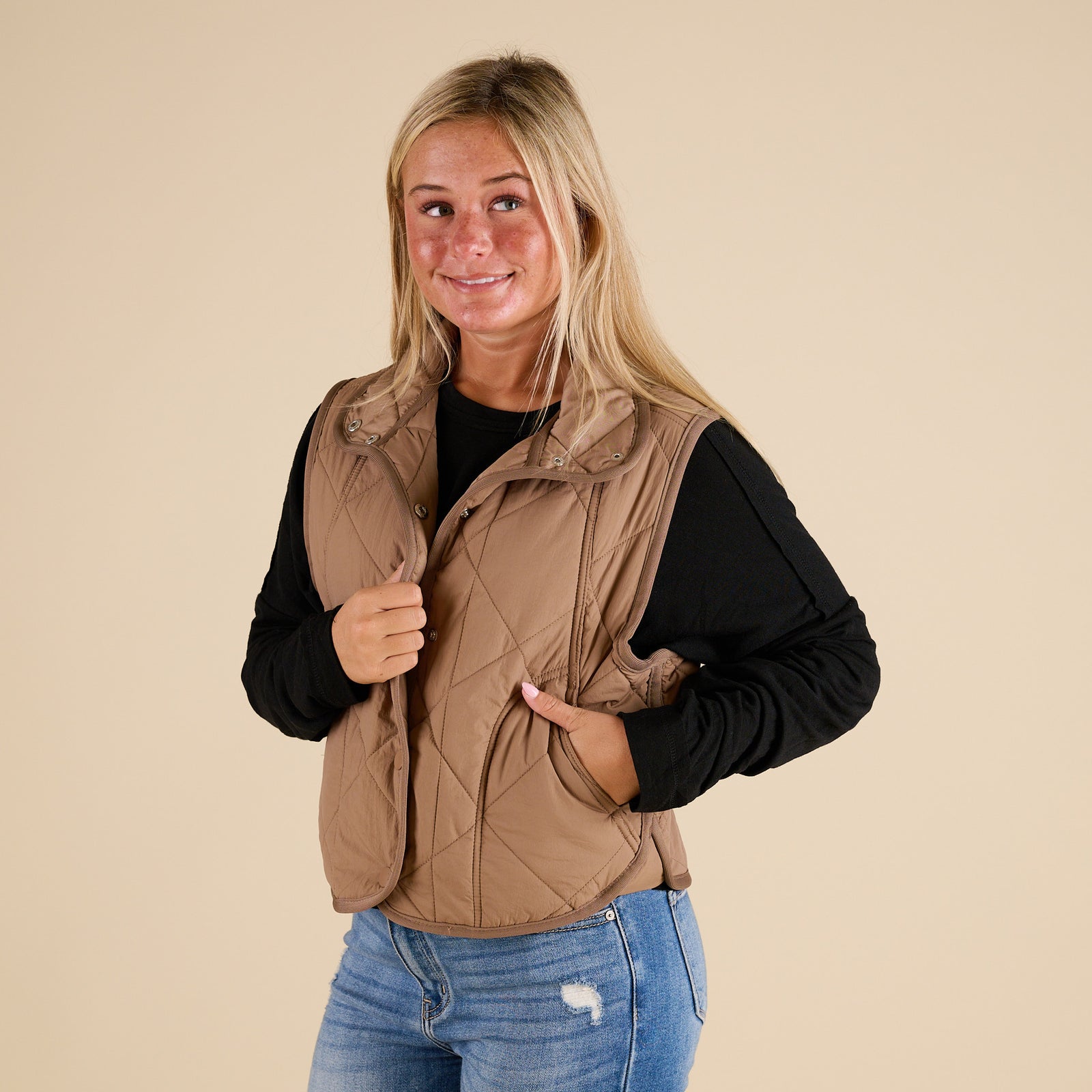 Blu Pepper Quilted Light Snap Vest in Mocha shown on model wearing a black long sleeve top and jeans, featuring quilted detailing and snap-front closure