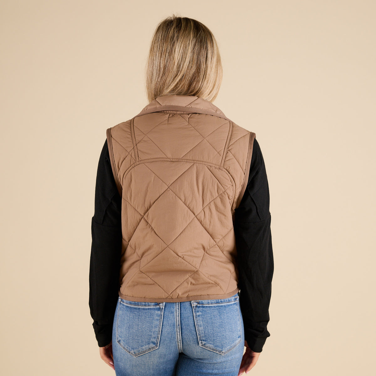 Blu Pepper Quilted Light Snap Vest in Mocha shown on model wearing a black long sleeve top and jeans, featuring quilted detailing and snap-front closure