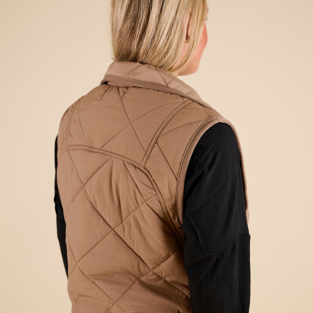 Blu Pepper Quilted Light Snap Vest in Mocha shown on model wearing a black long sleeve top and jeans, featuring quilted detailing and snap-front closure