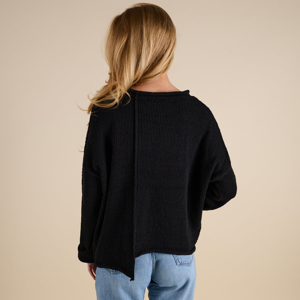 Model wearing Asymmetrical Hem Light Weight Sweater in black