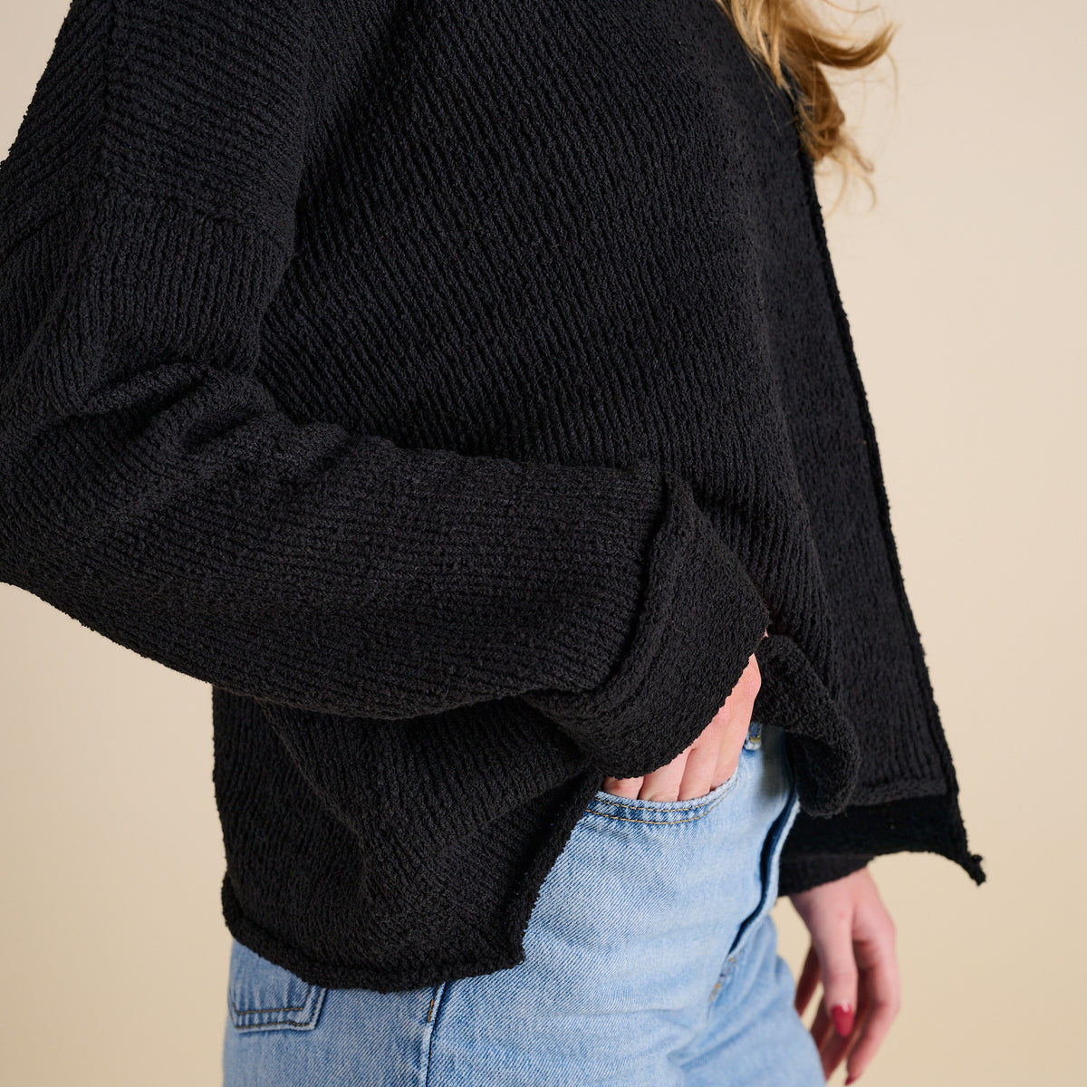 Model wearing Asymmetrical Hem Light Weight Sweater in black