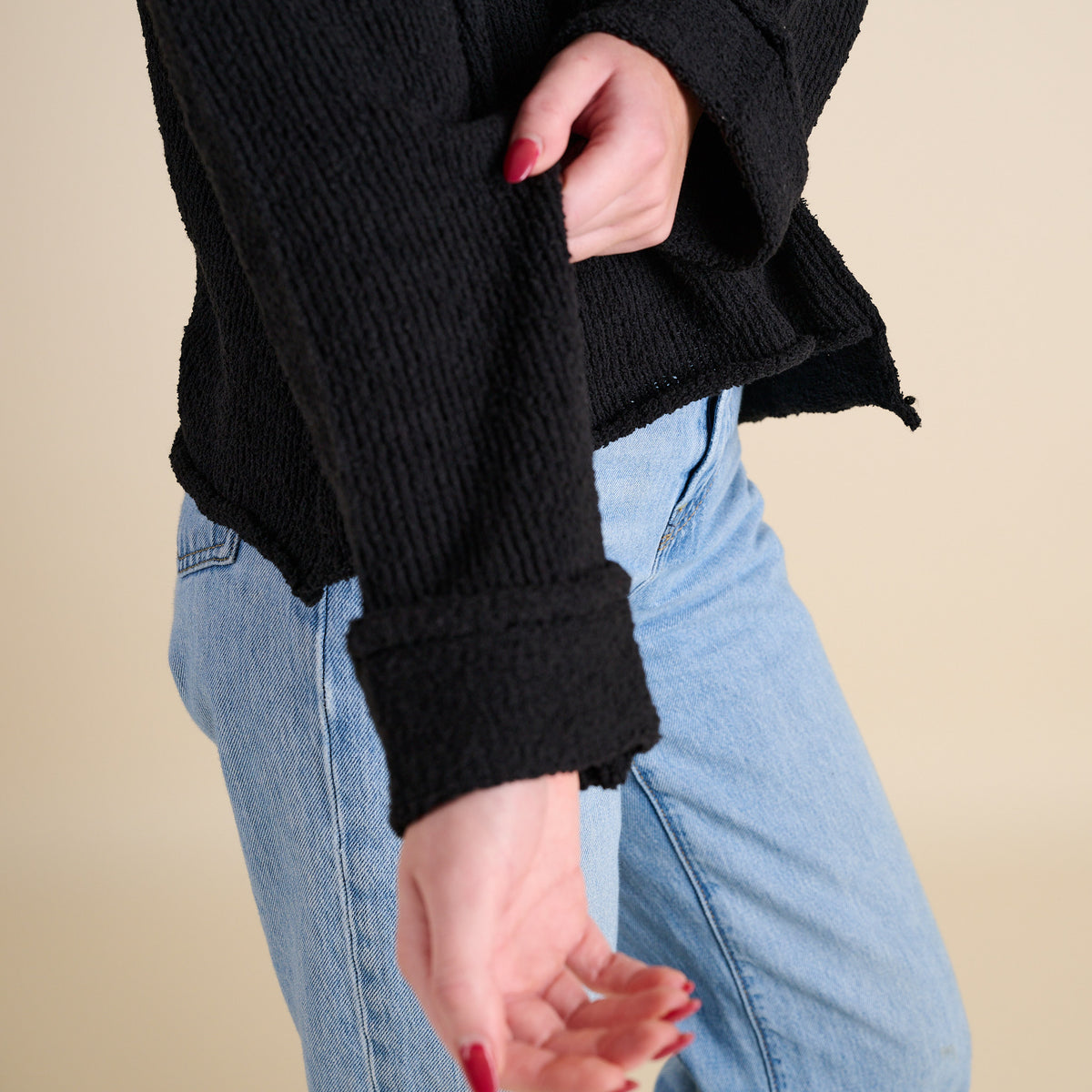 Model wearing Asymmetrical Hem Light Weight Sweater in black