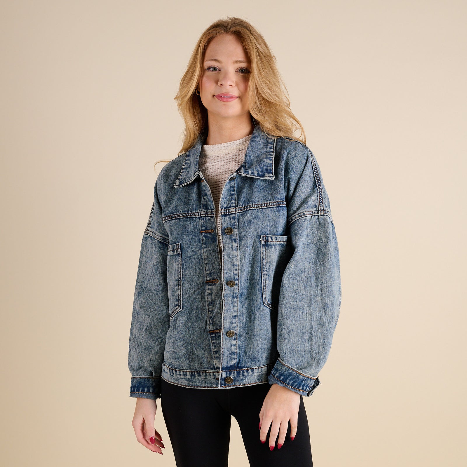 Woman wearing Dark Wash Denim Jacket by Rivalry Runway on a beige background