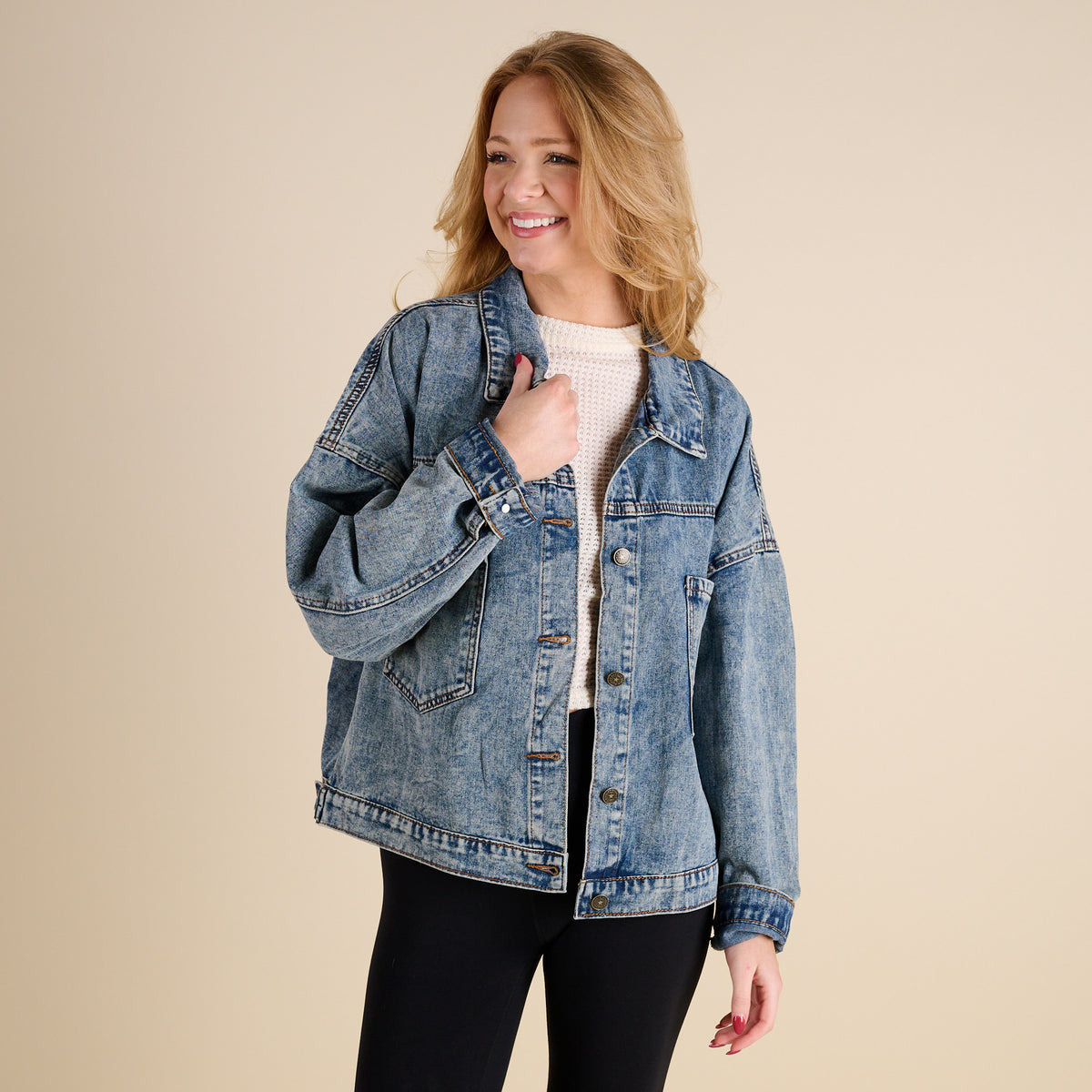 Woman wearing Dark Wash Denim Jacket by Rivalry Runway on a beige background