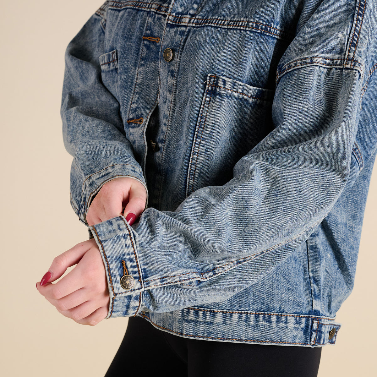 Woman wearing Dark Wash Denim Jacket by Rivalry Runway on a beige background