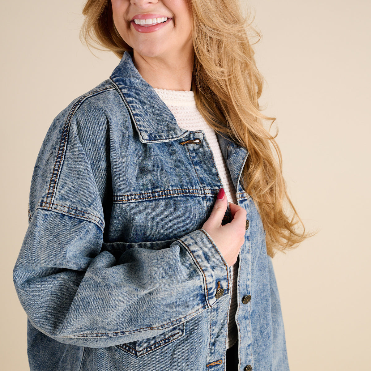 Woman wearing Dark Wash Denim Jacket by Rivalry Runway on a beige background