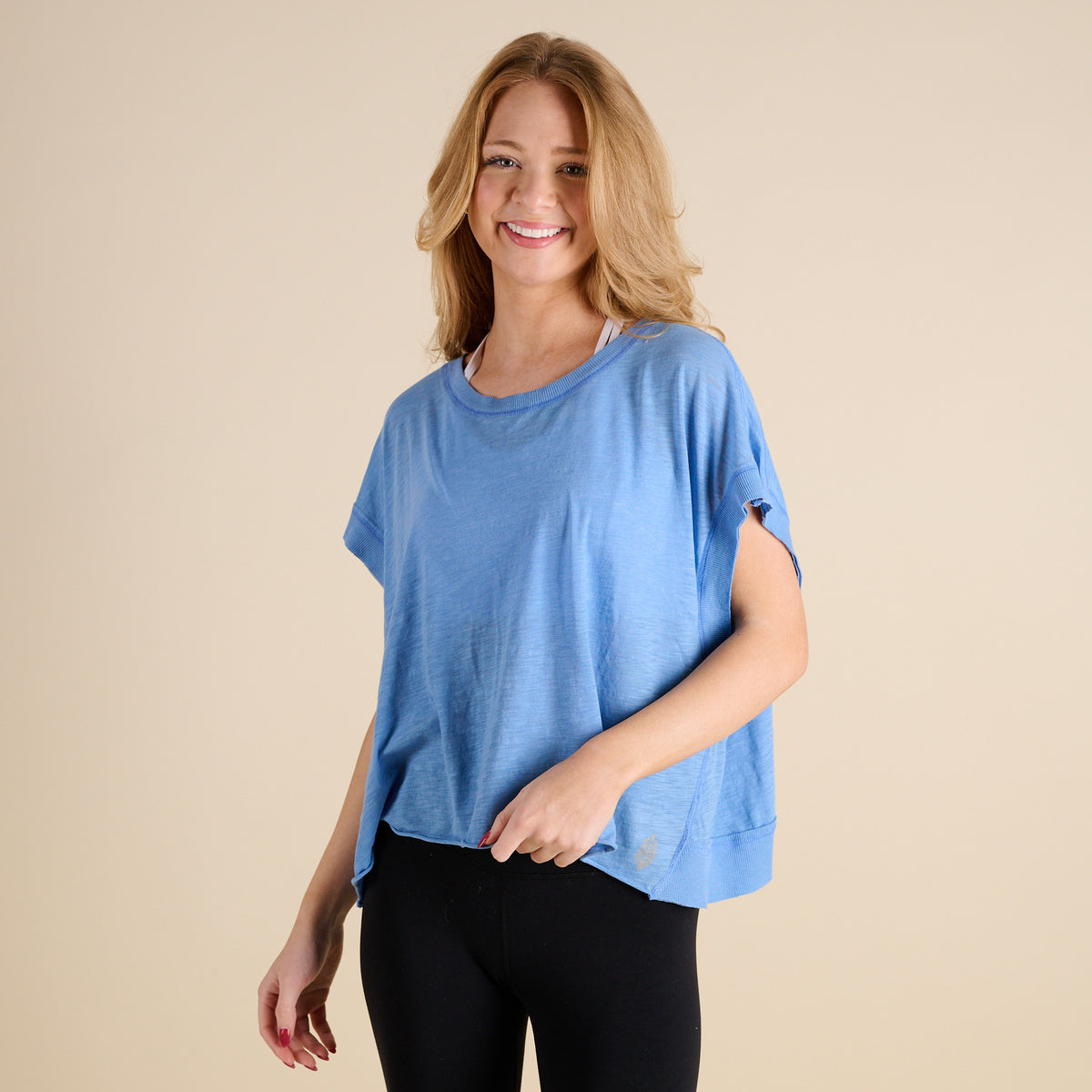 woman wearing FP Movement My Time Tee in Denim on beige background