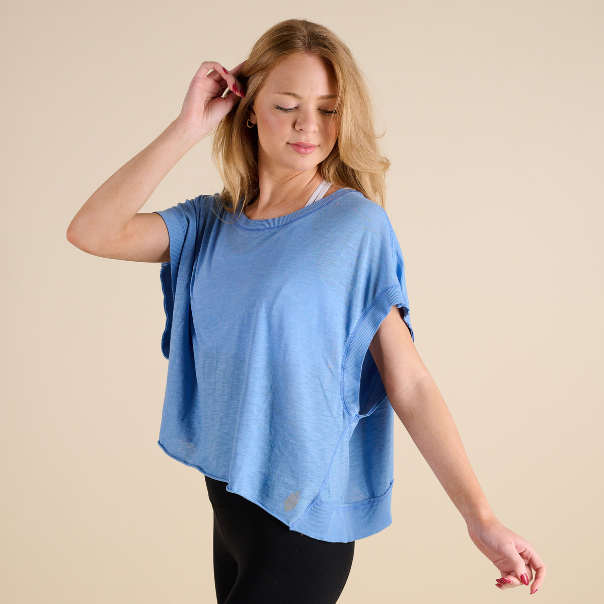 woman wearing FP Movement My Time Tee in Denim on beige background