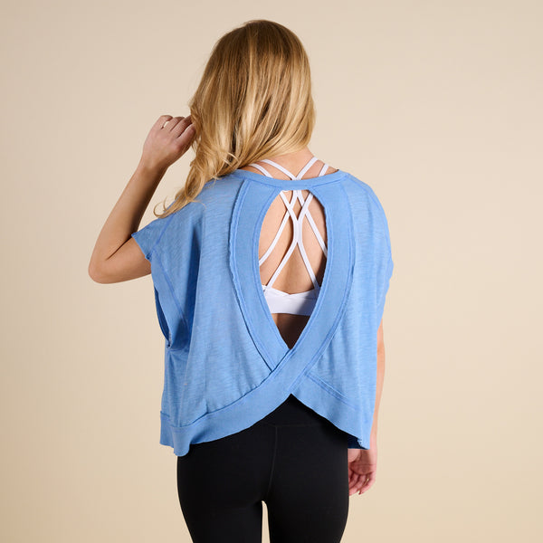 woman wearing FP Movement My Time Tee in Denim on beige background