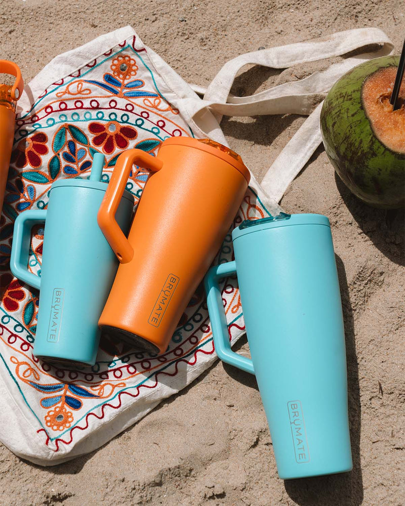 Brumate tumblers pictured on the beach.