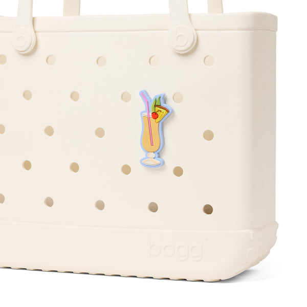 Bogg Bag Bogg Bits in Pina Colada attached to a beige Bogg Bag shown on a white background