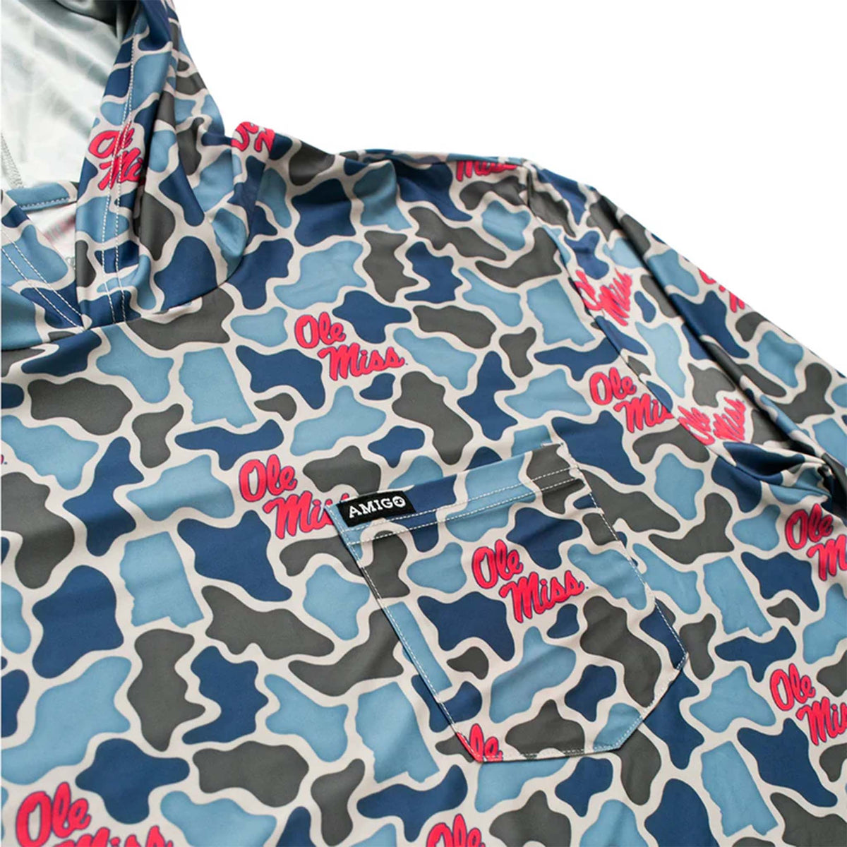 Detailed view of chest area on Ole Miss camo hoodie with red logos, front pocket, and Amigo Provisions tag stitched above the pocket.