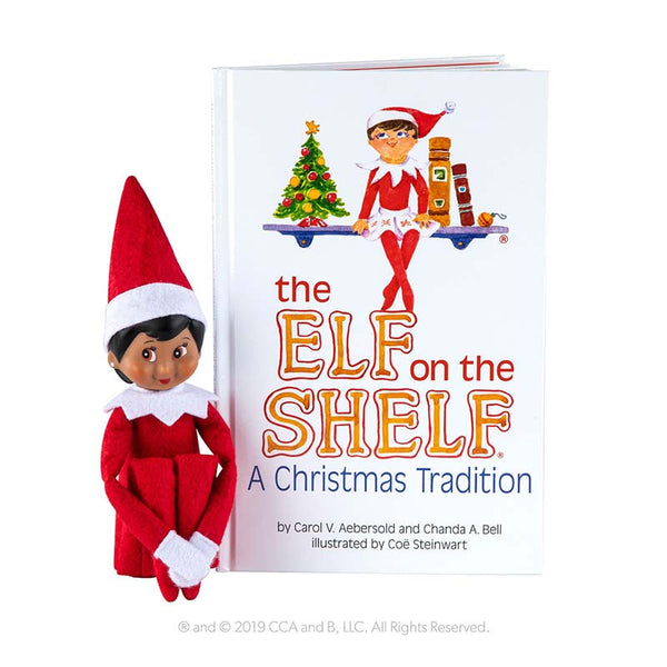 Brown eyed girl Elf on The Shelf doll with Christmas Tradition book.