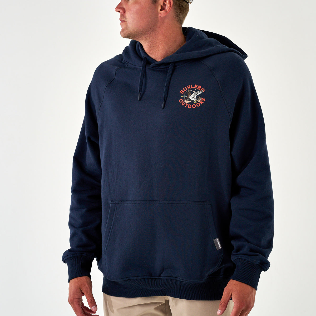 Close-up of kangaroo pocket and ribbed hem on Burlebo Outdoors navy hoodie.
