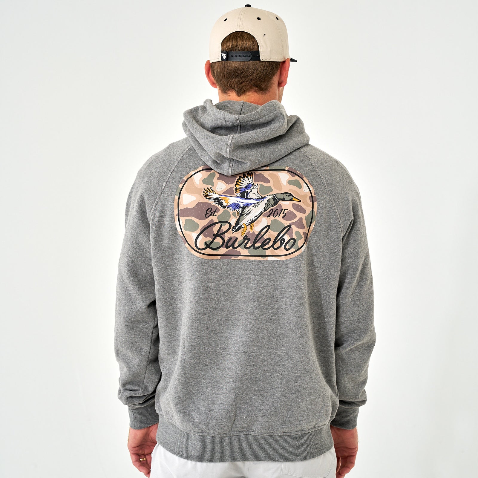 Back view of Burlebo gray hoodie with large camo oval patch featuring flying duck, “Burlebo” text, and “Est. 2015.”
