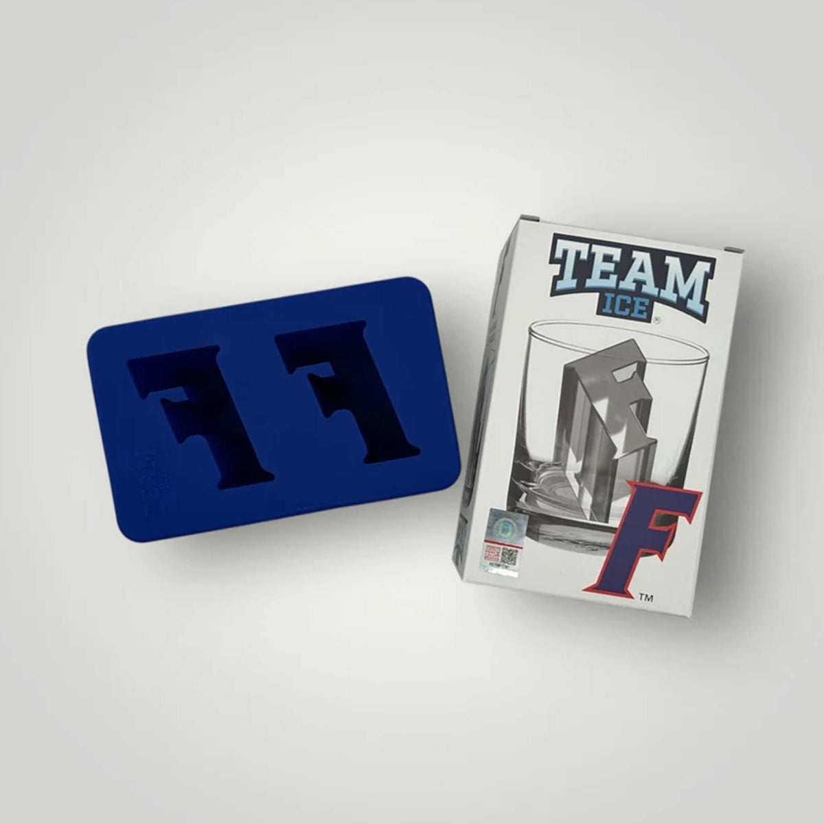 Blue silicone mold with two F-shaped cavities and branded box beside it